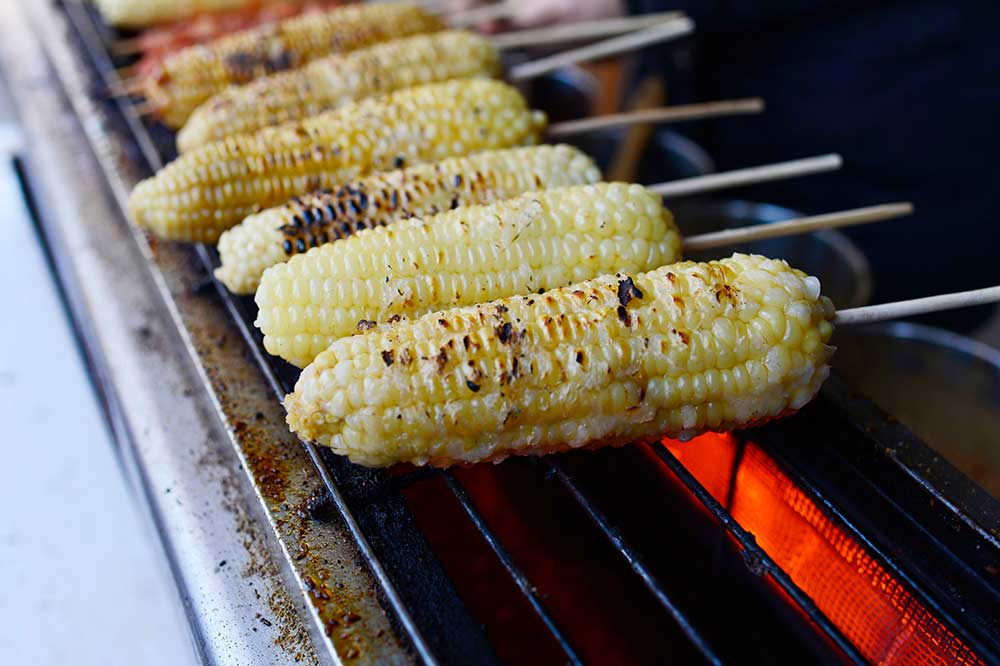 White corn on barbecue grill.