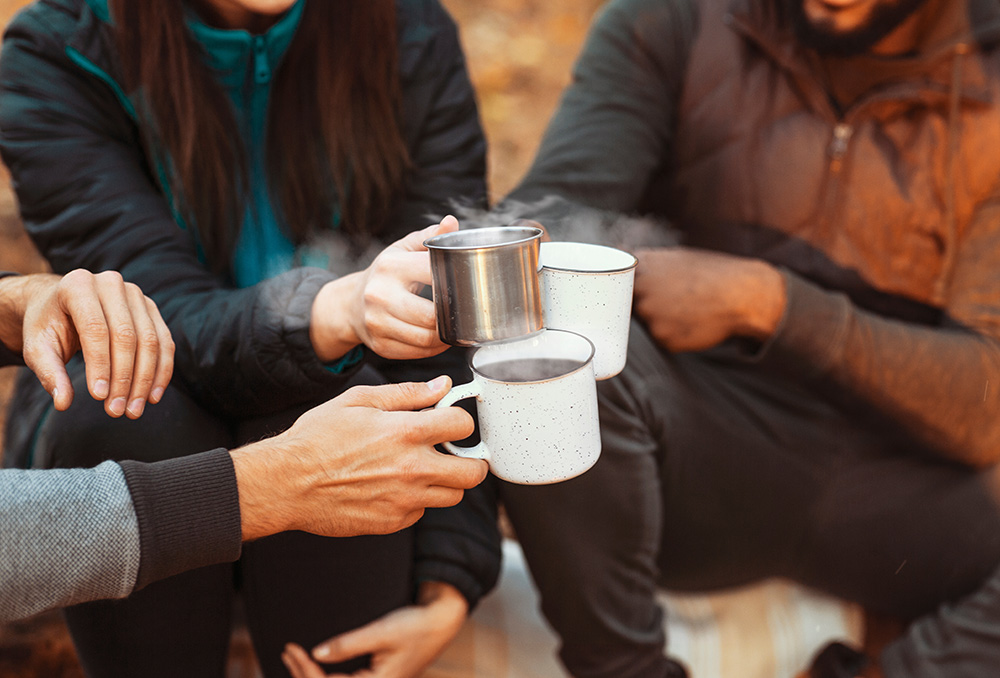 People cheering with cups of coffee.