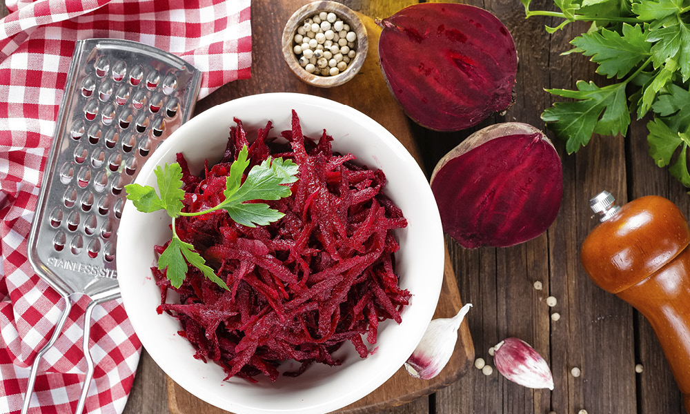 Red beets grated and sliced in half.