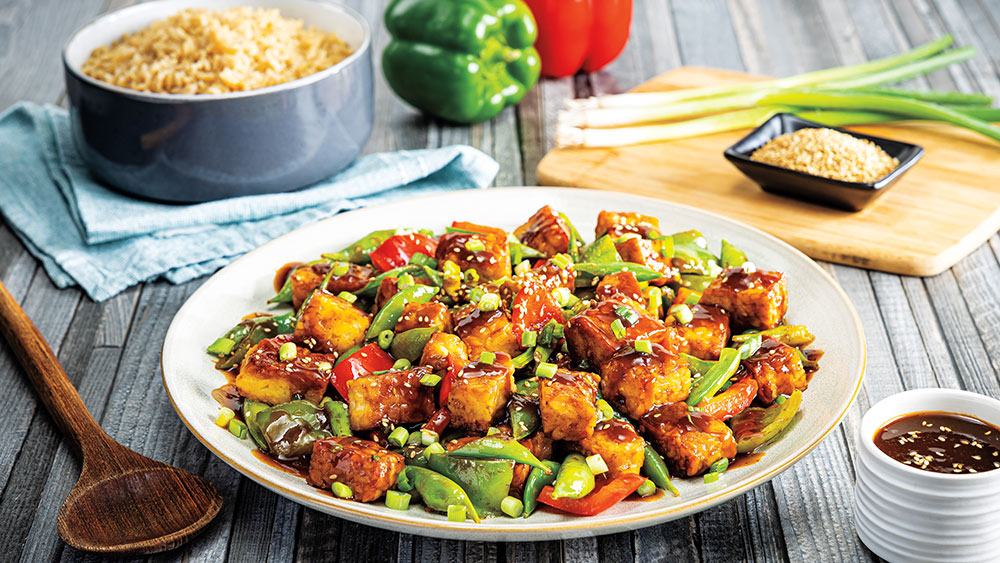 Vegan kung pao tempeh with fresh vegetables.