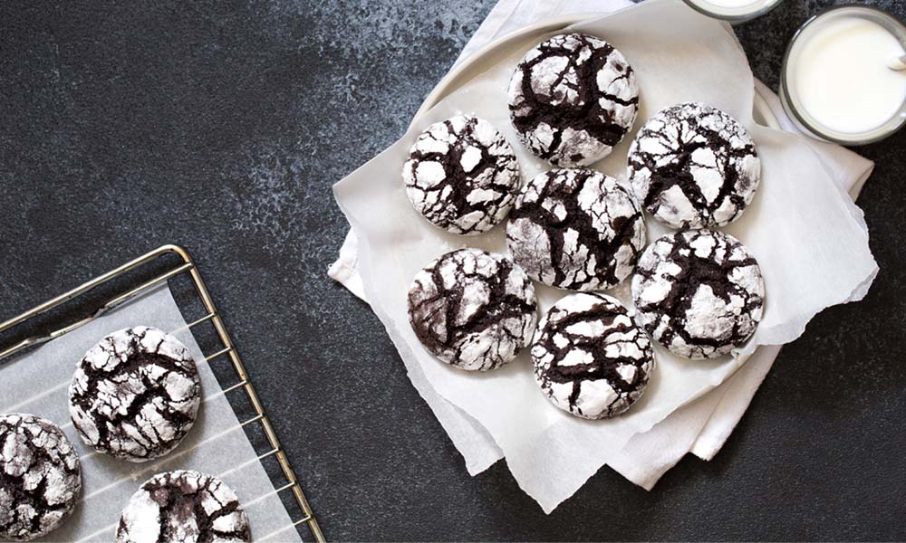 Chocolate cookies dusted in powdered sugar served with milk. 