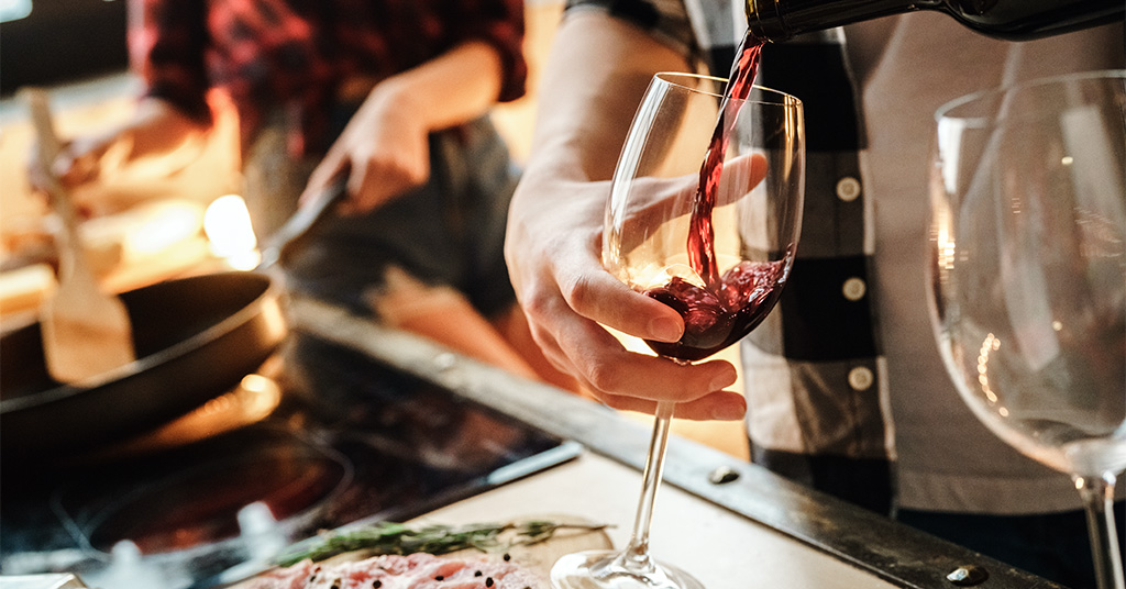 Couple Preparing for At Home Date Night With Food and Wine