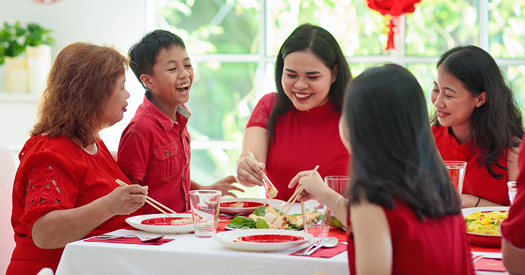 Family celebrating lunar new year dressed in red.
