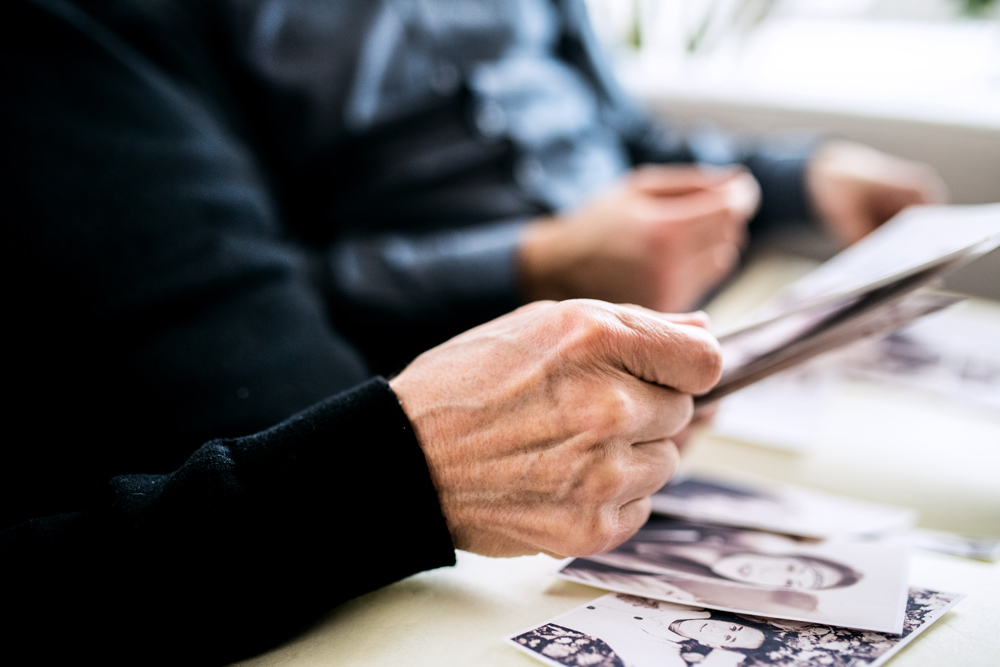 Two family members reminiscing by looking at old family photos.