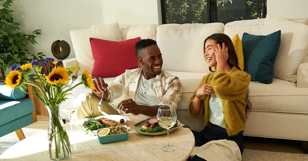 Couple laughing together in living room