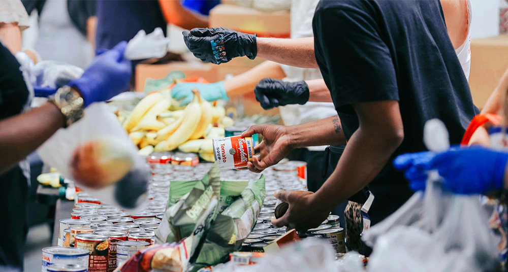 People handing out food at a food bank.