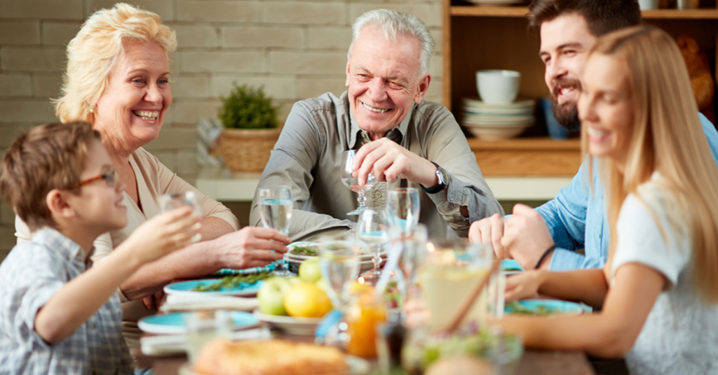 Family sitting down eating dinner.