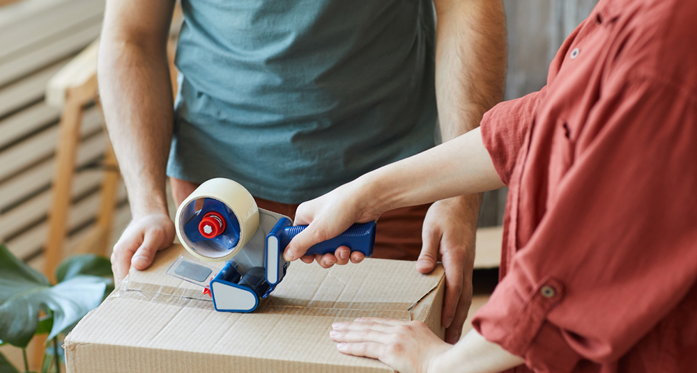 A couple building a box for donations.