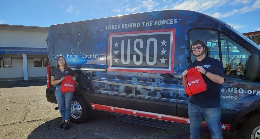 USO team standing in front of their van. 