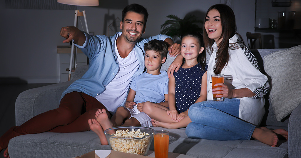 Family Sitting on a couch enjoying a movie