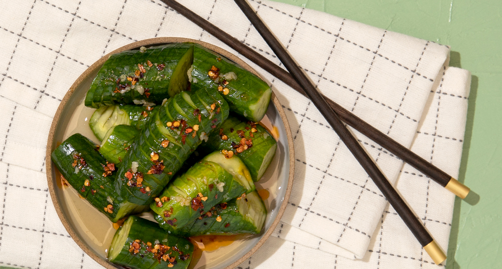 Plate With Chop Sticks and Cucumber Salad With Chili Oil.
