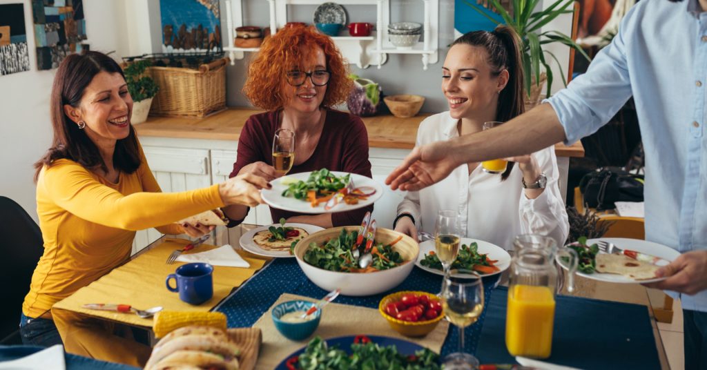 Family gathering while eating salads.