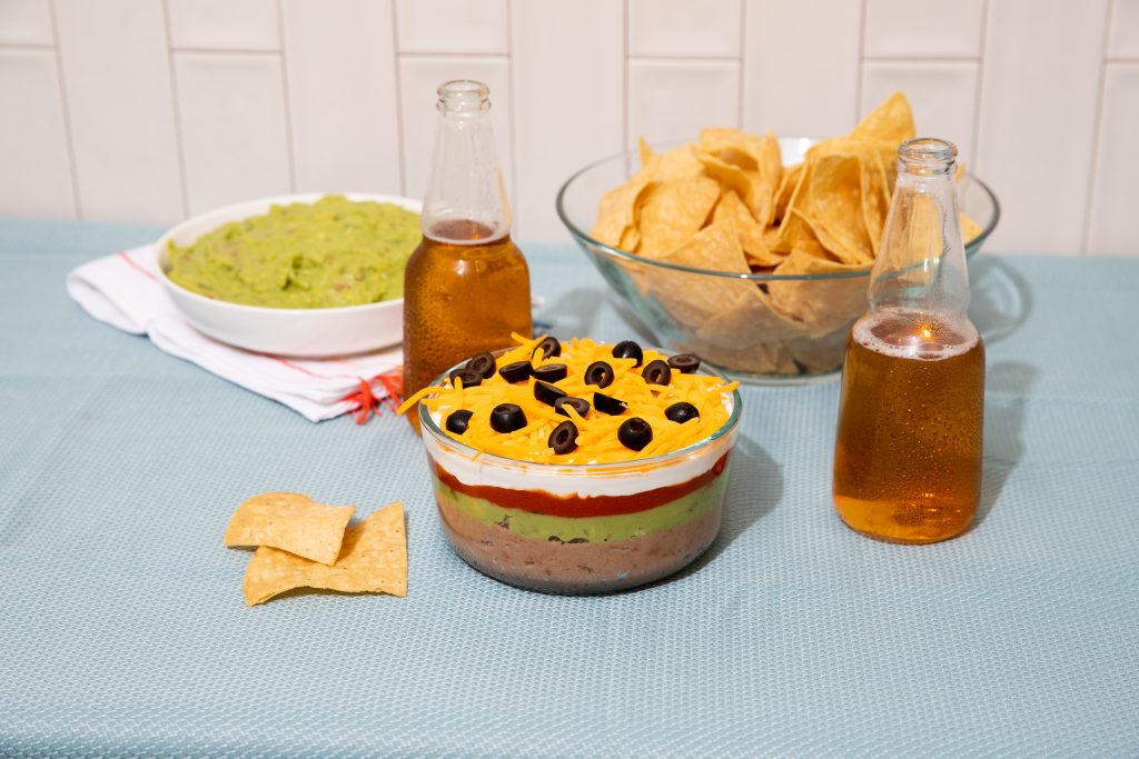 Stater Bros. Markets Service Deli 6 Layer Dip Served With Fresh Cut Guacamole and a Modelo Beer