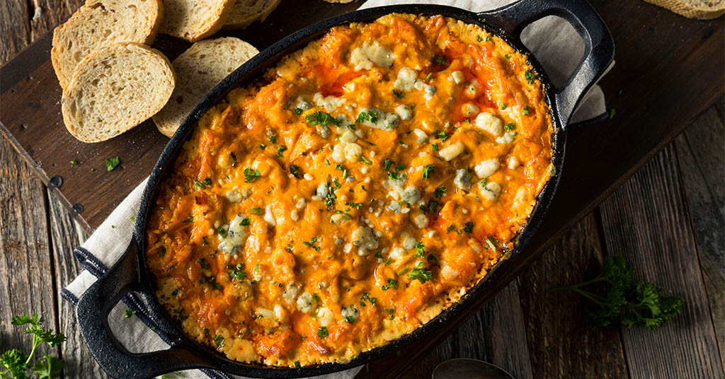 Cast Iron Skillet with Buffalo Chicken Dip and Blue Cheese Crumbles Served With Bread