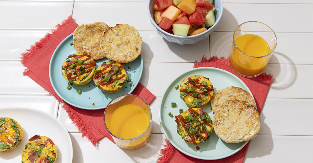 Healthy turkey bacon egg bites for a quick breakfast made with tomatoes, green onion, spinach, and cheese. 