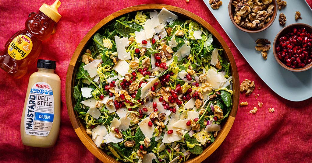 Shaved brussels sprouts salad made with parmesan cheese, walnuts, pomegranates, and a dijon mustard dressing for spring.