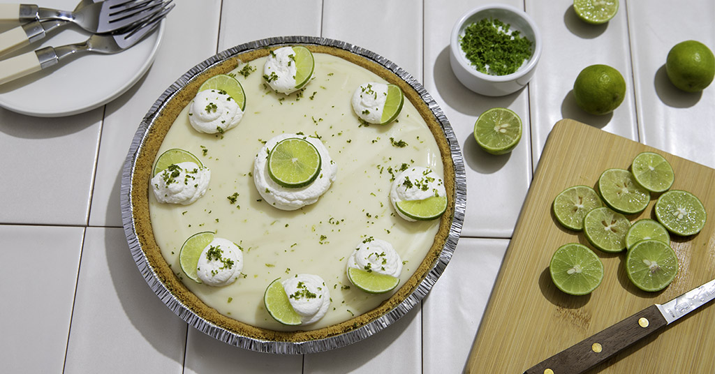 Key Lime Pie with Limes and Whipped Cream