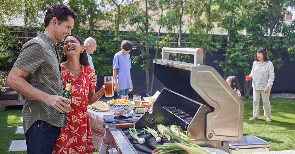 Family grilling food outside.